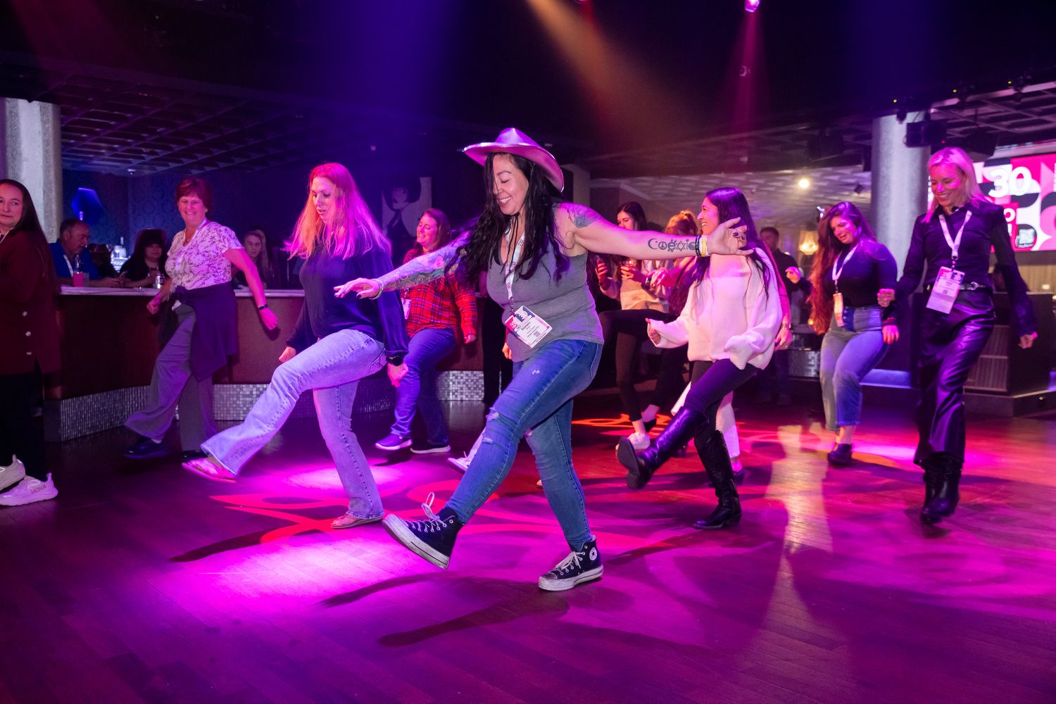 Largo group on dance floor wearing cowboy hats and dancing